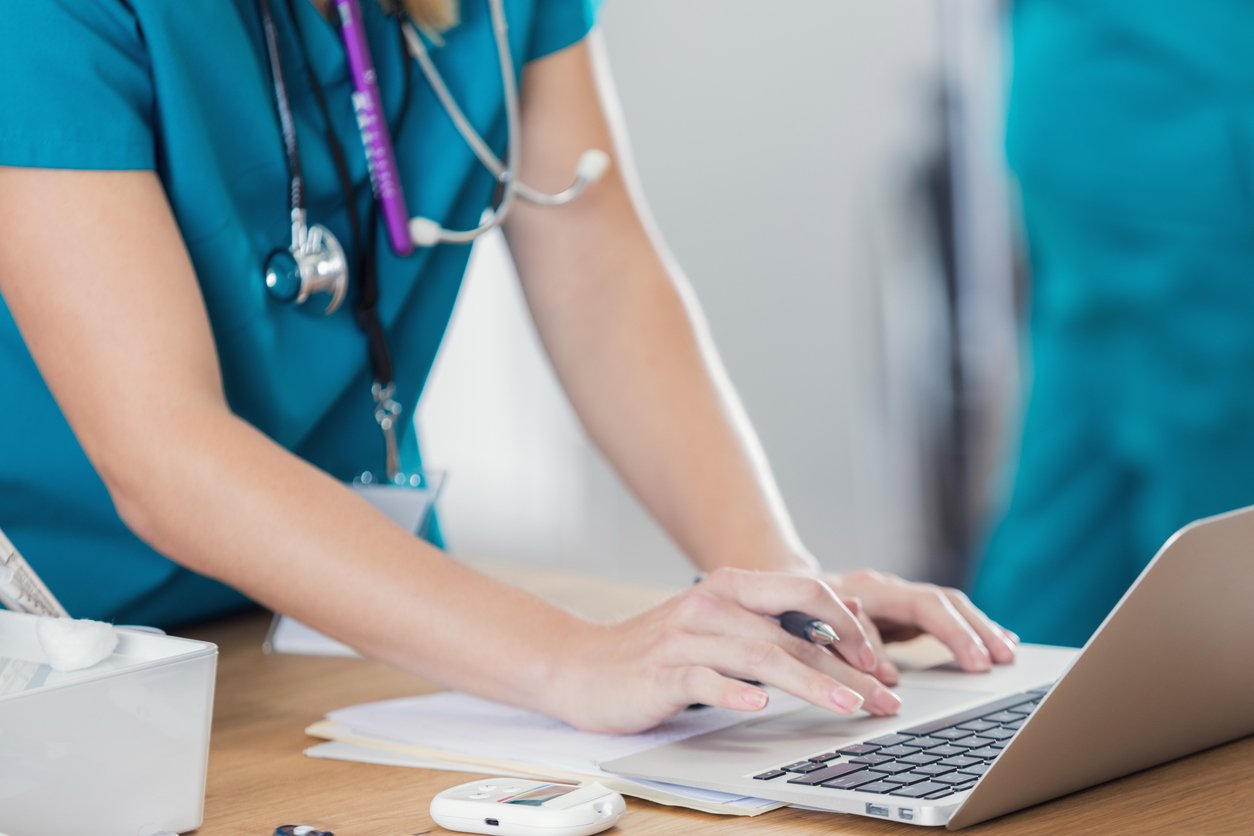 Nurse logging into computer