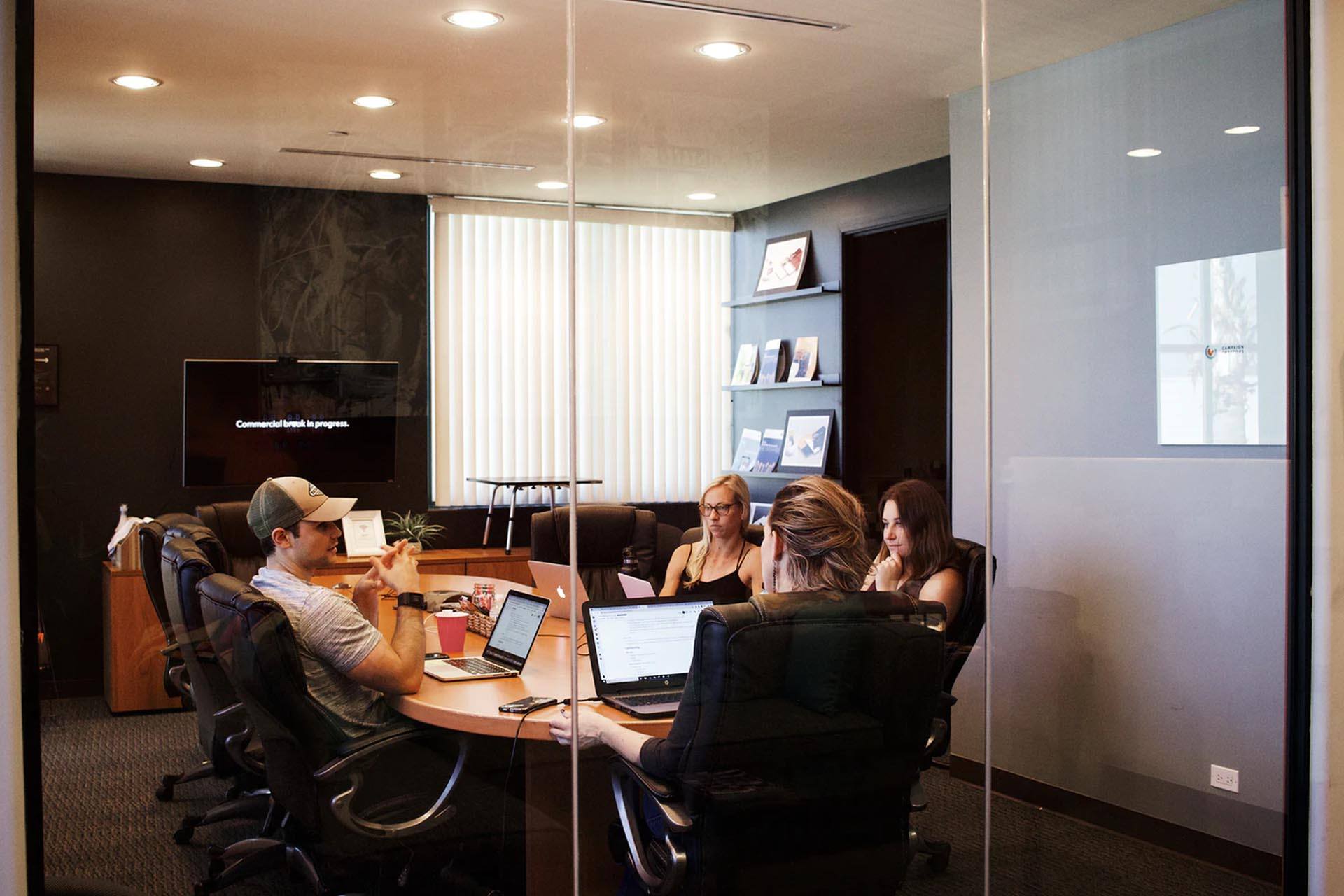 Boardroom meeting of business executives around a mahogany table.